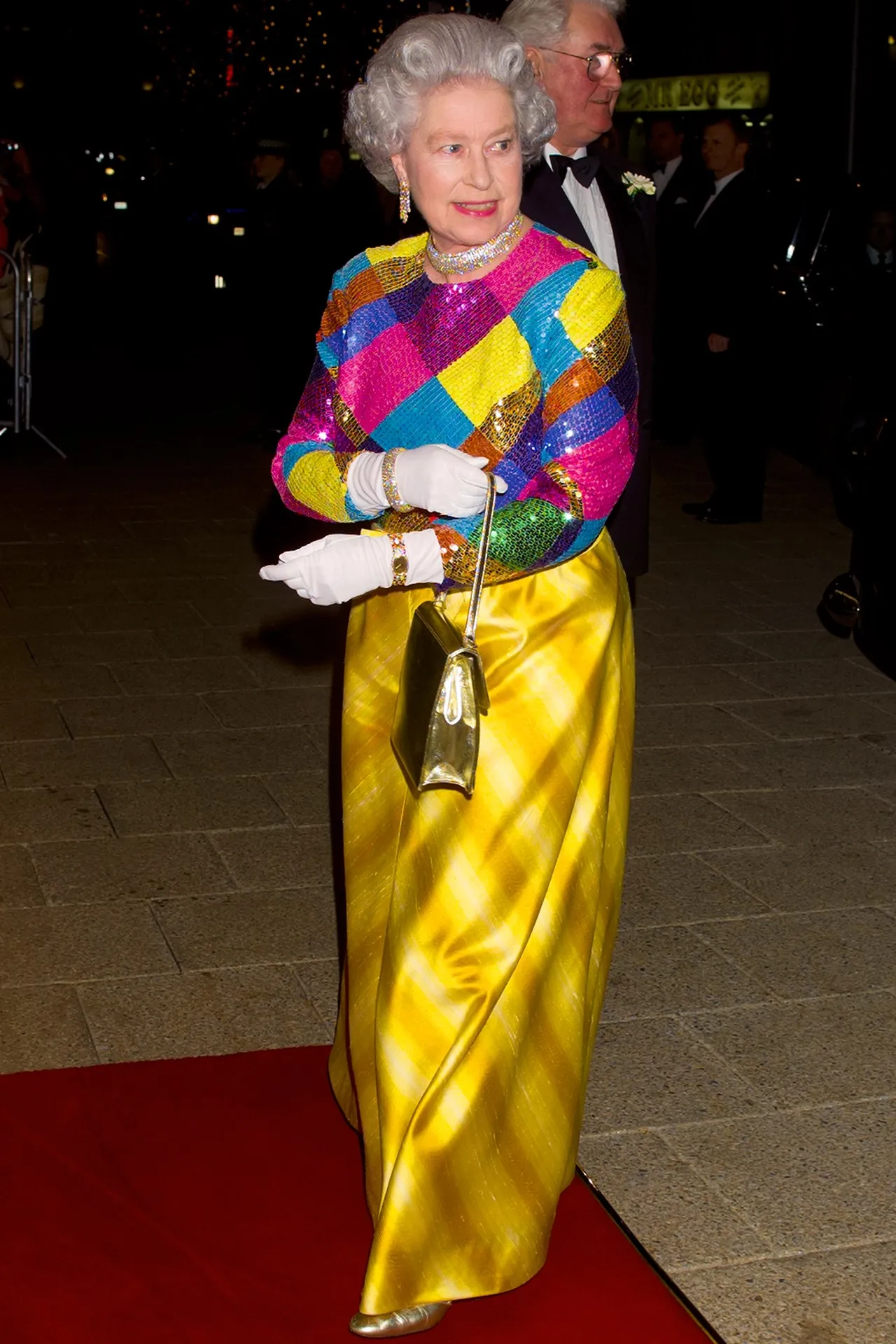The Queen wearing a bright sequin top and gold skirt to the Royal Variety Performance in 1999