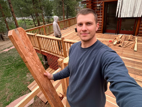 Technician from Fix Rabbit working on deck repair and staining project, preparing wood boards for staining in Denver Metro Area.
