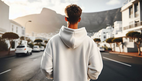 a south african man is standing with back to camera in a cape town, the man is wearing a w