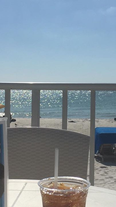 Photo of a the view (sand and water) while sitting at a table at Mango's Tiki Bar across the street at the DoubleTree.