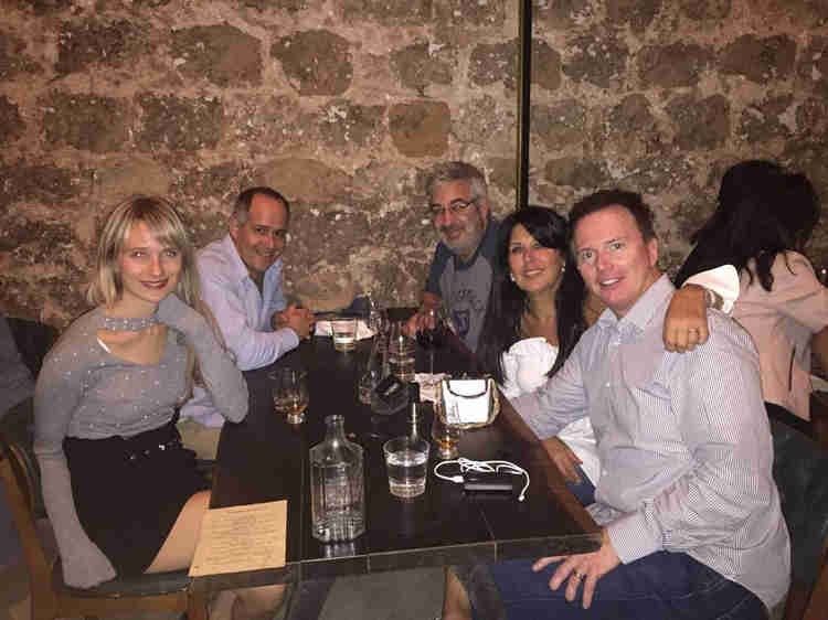 Eedie and Mark Fitzsimmons enjoying a meal at a restaurant with a few friends