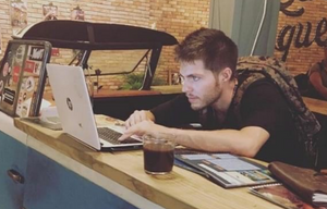Oleh Jacob Feldman working on a laptop at a counter