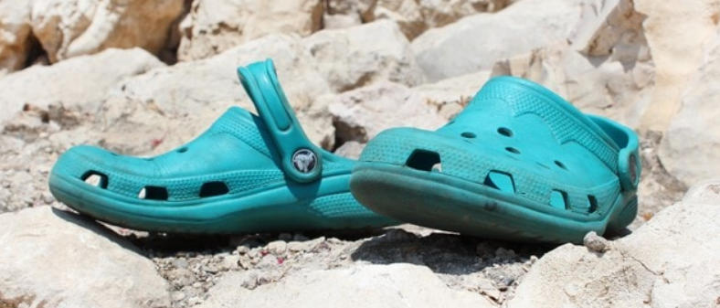 Blue crocs on a pile of stones