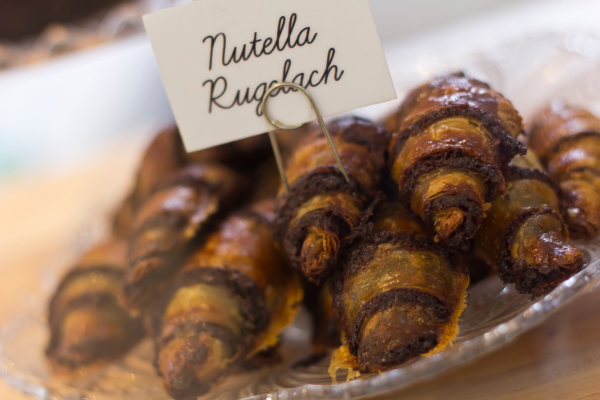 A stack the Israeli dessert, rugalah on a plate with the sign 'Nutella Rugalach'