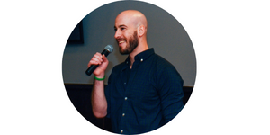 Oleh, David Baskin holding a microphone while giving a speech