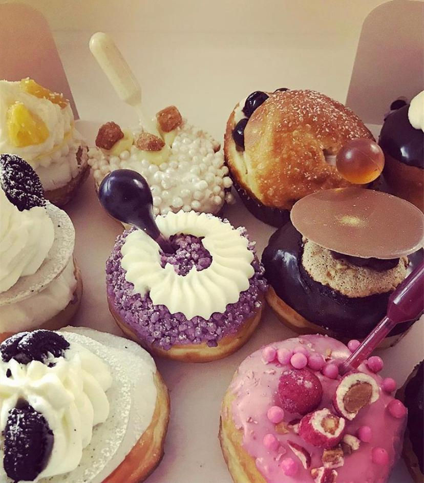 Decorated sufganiyot with various toppings and fillings