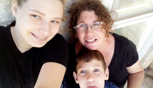 Olah Lauren Adilev with one of her children on her lap and the other taking a selfie of them all