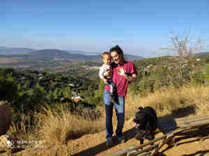 #Meet_the_Oleh, Maddie De Silva's husband holding their son and their black dog at their feet