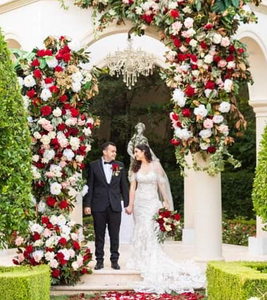 Olah Chantelle Leiderman and her husband holding hands under a wedding huppah