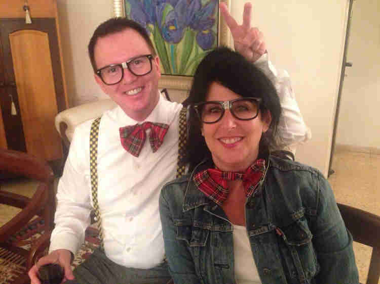 Mark Fitzsimmons giving bunny ears to Eedie Fitzsimmons with both wearing large glasses and plaid bowties