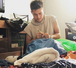 Oleh Jacob Feldman holding a marker over a plastic bag he marked