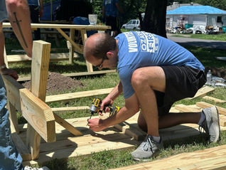 Volunteer building a picnic table