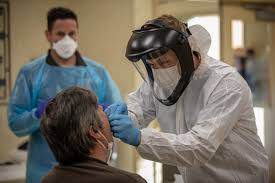 Healthcare worker performing Covid test on patient