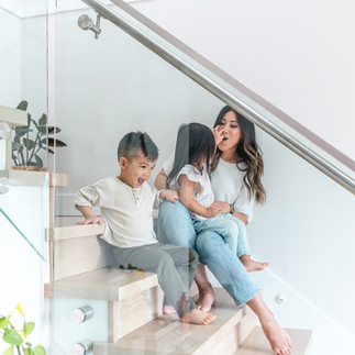 3. Mom and two kids sitting on the stairs during a relaxed lifestyle session.