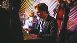 image of Mark Davis playing the piano in a jazz club
