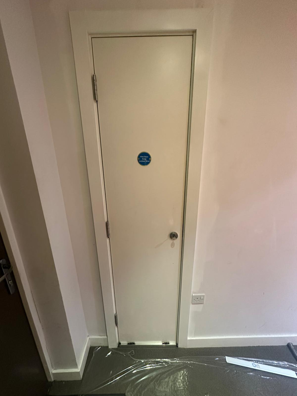 Single service-cupboard doorset with fire-door signage, Barlett Park