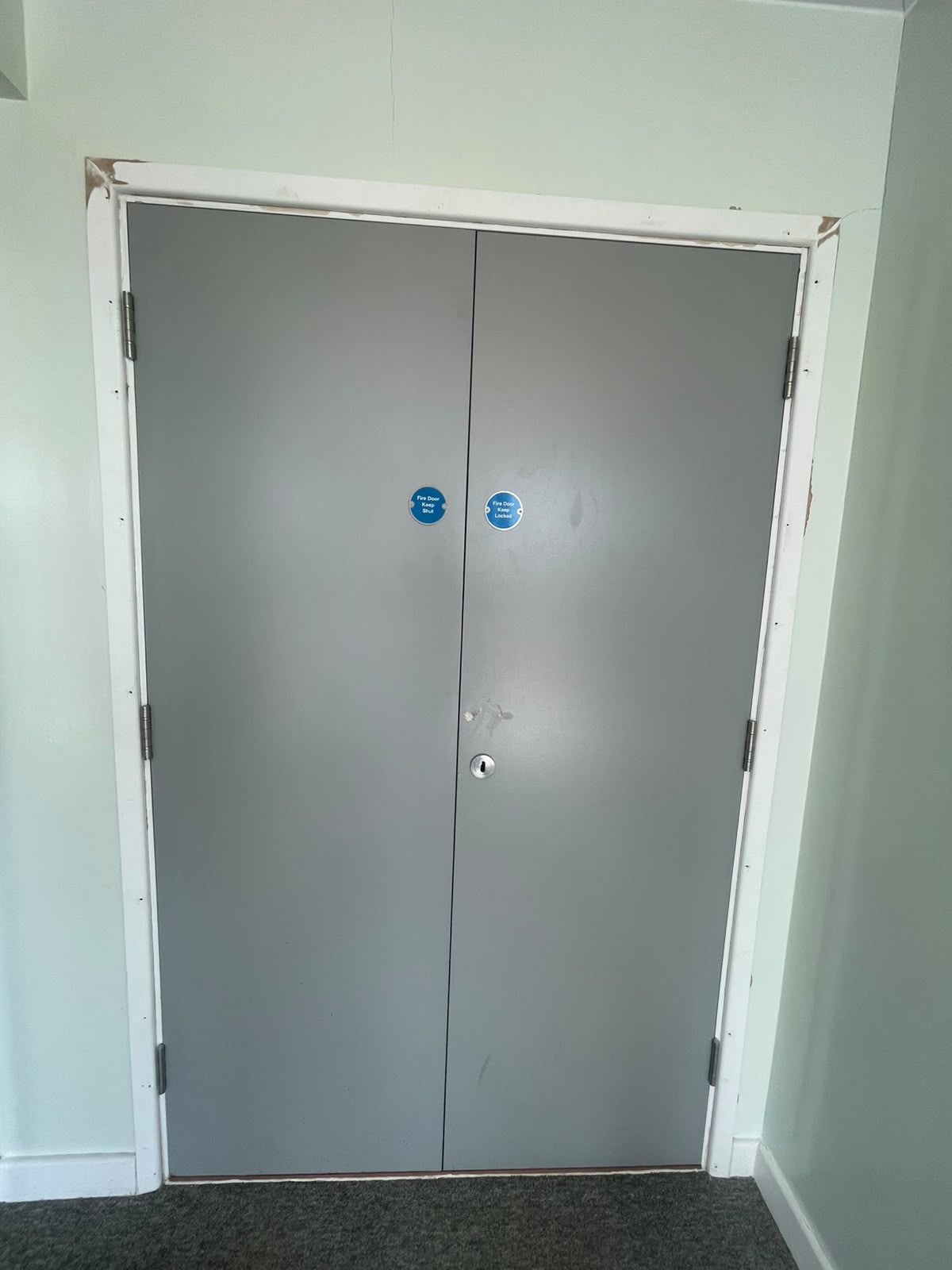 Paired grey doors with fire-door signage, Radcliff Court