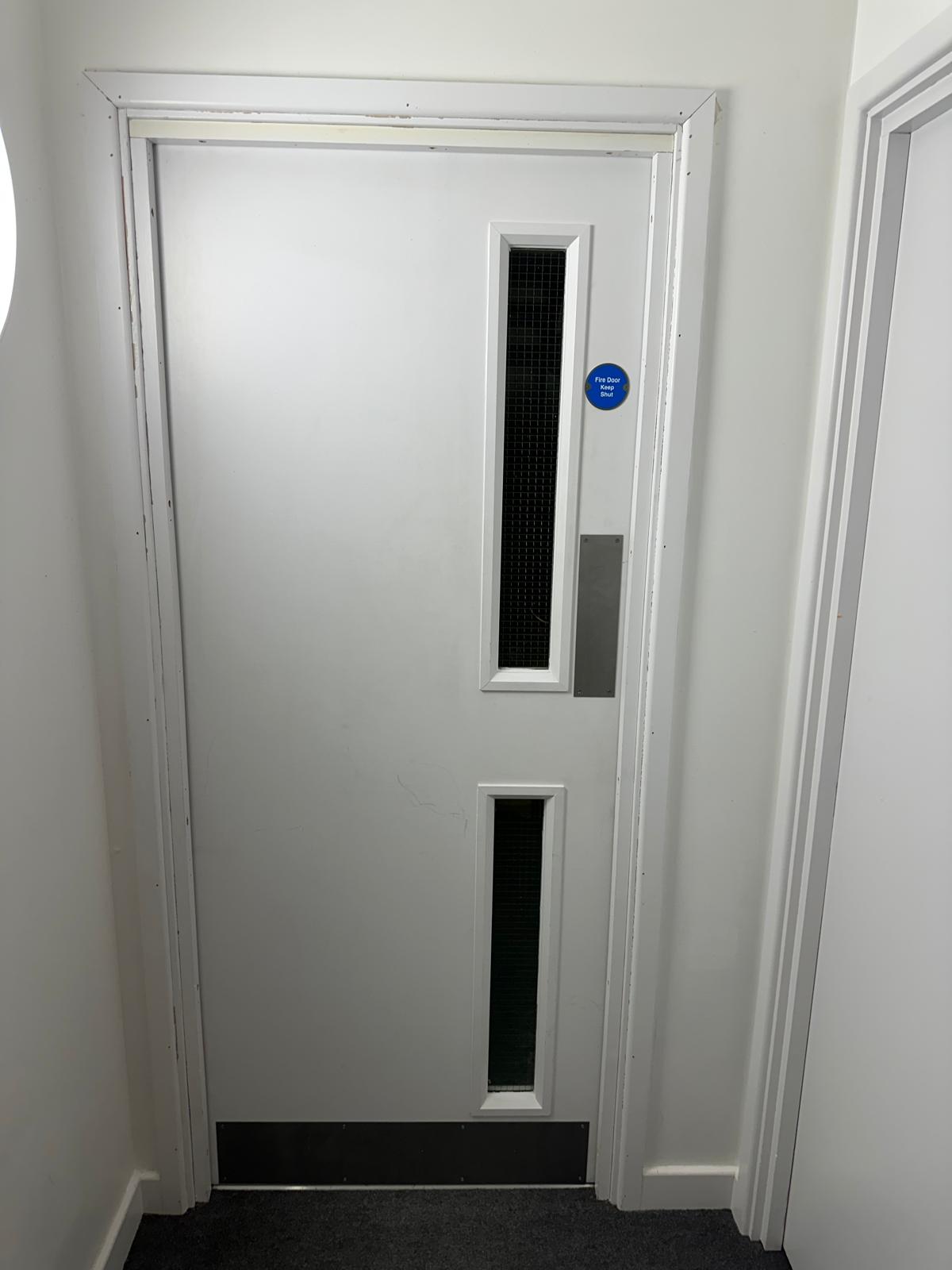 White-painted glazed corridor door, Warwick Apartments