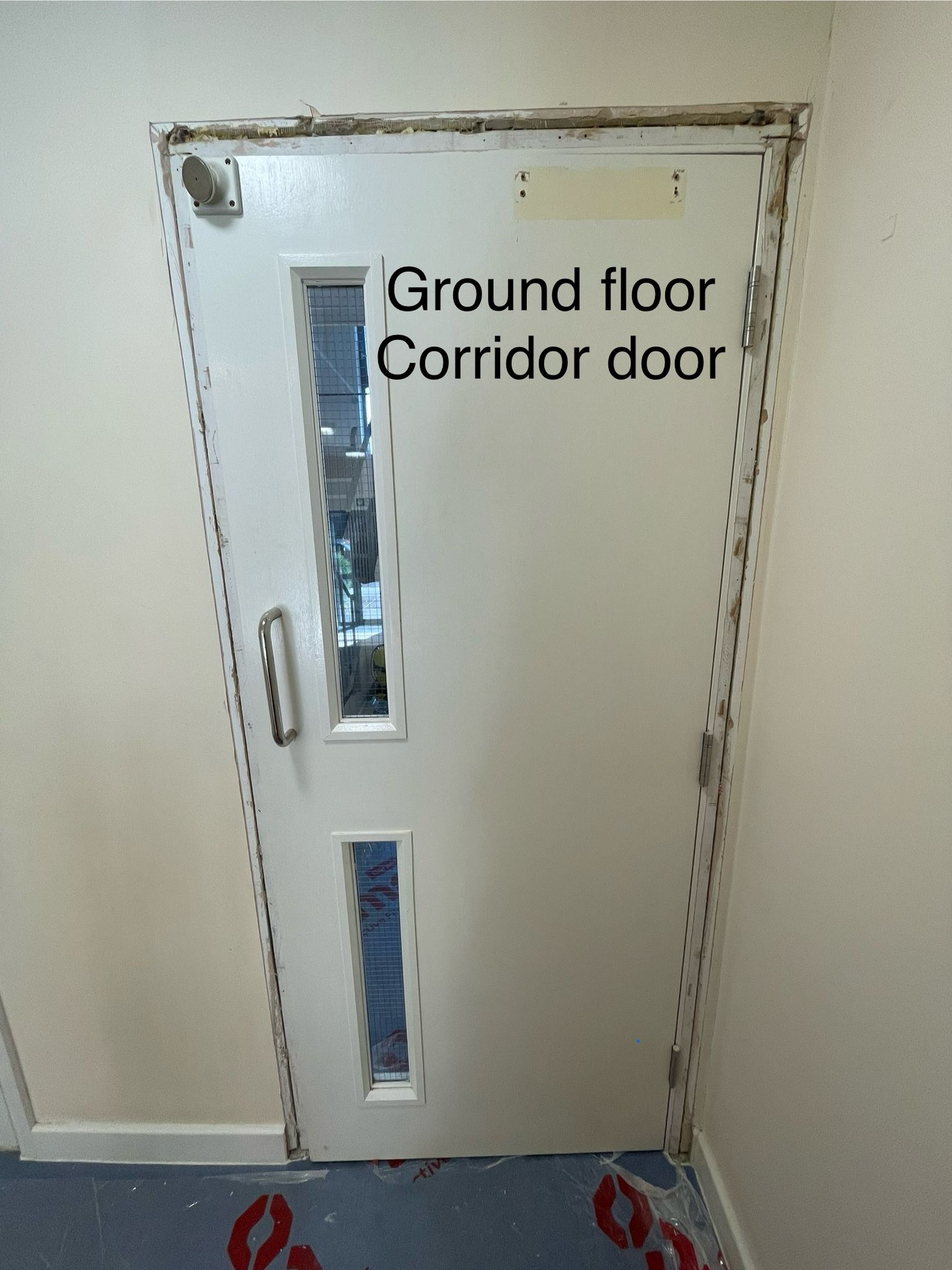 Corridor door during perimeter works, Ilsley Court