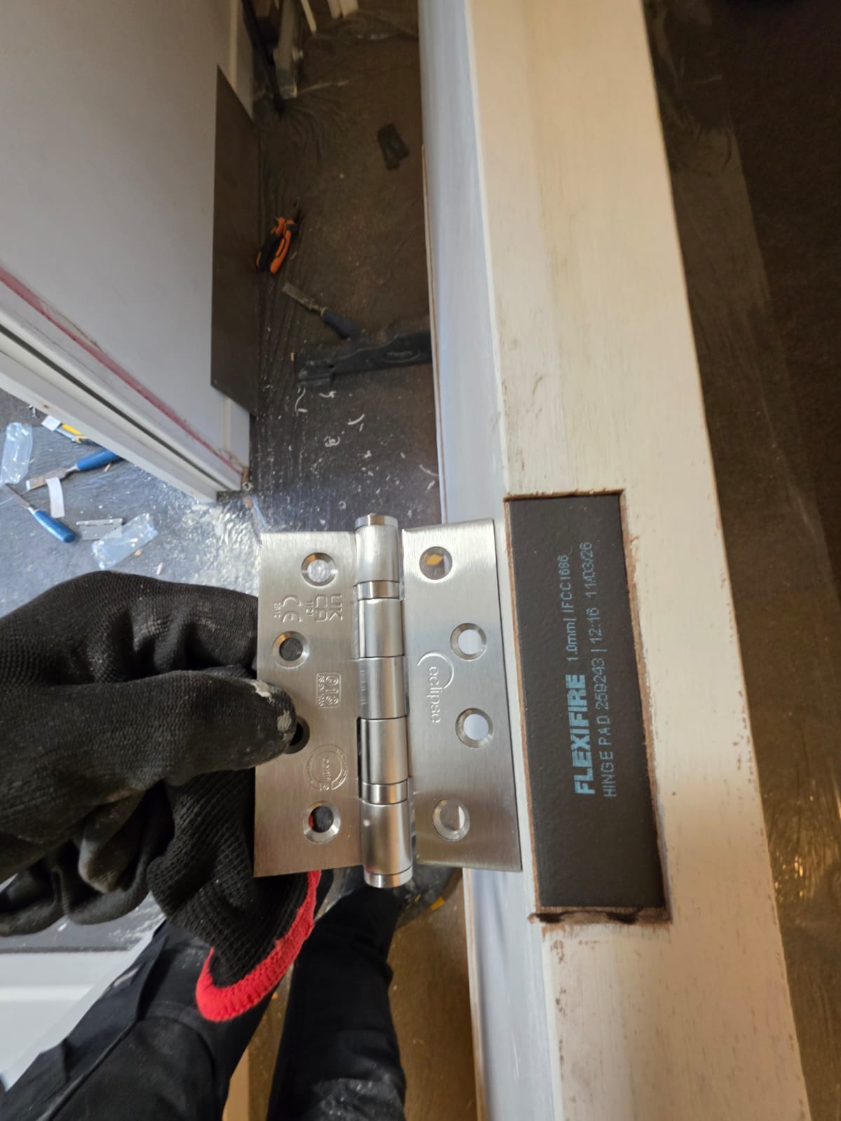 Hinge preparation during maintenance, Blenheim Apartments
