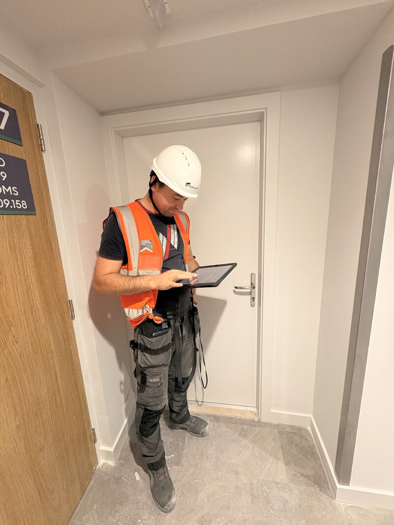 Project team member recording information on a tablet, Paragon Estate
