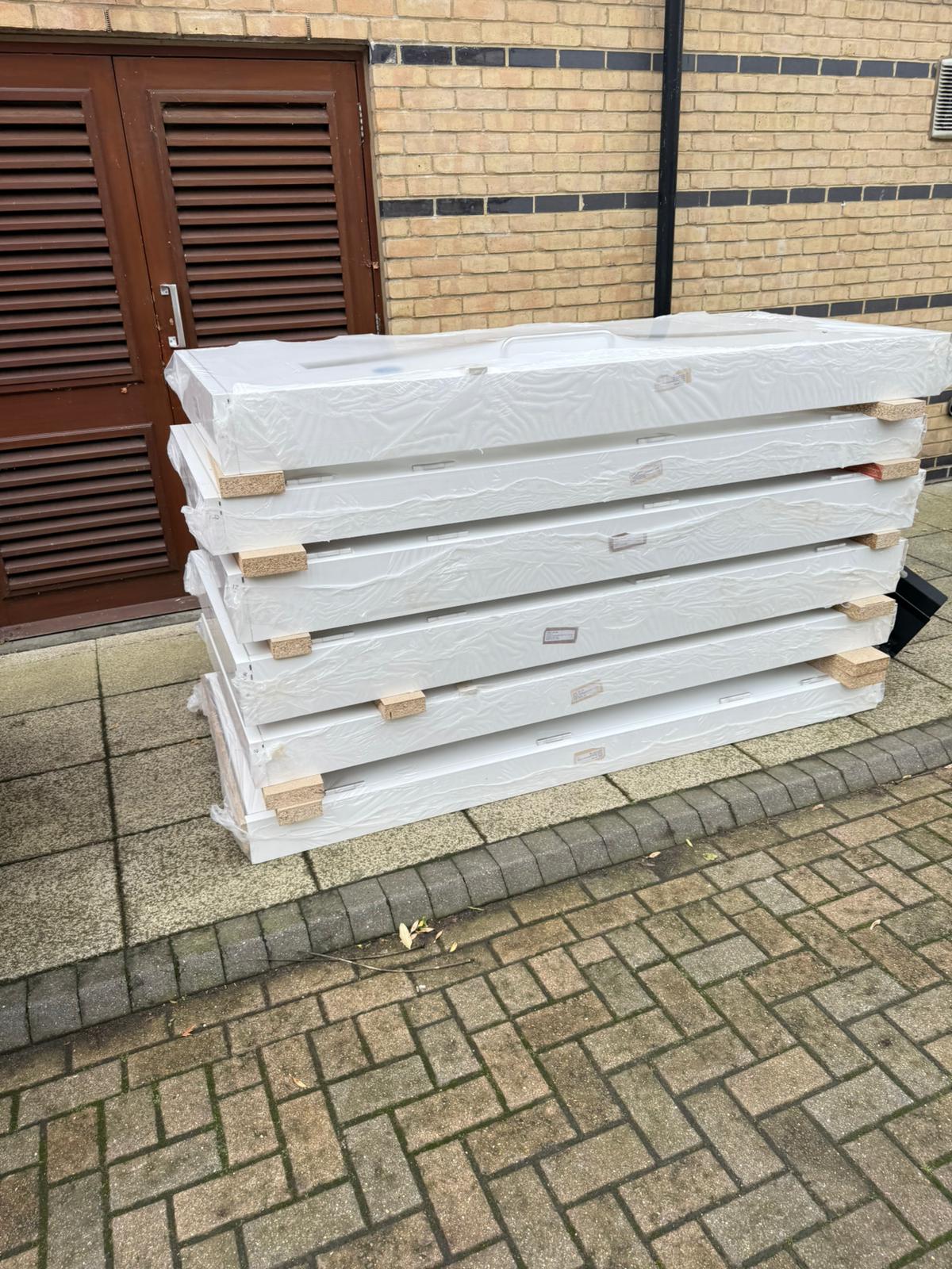 Wrapped door components outside the building, Tynee Court