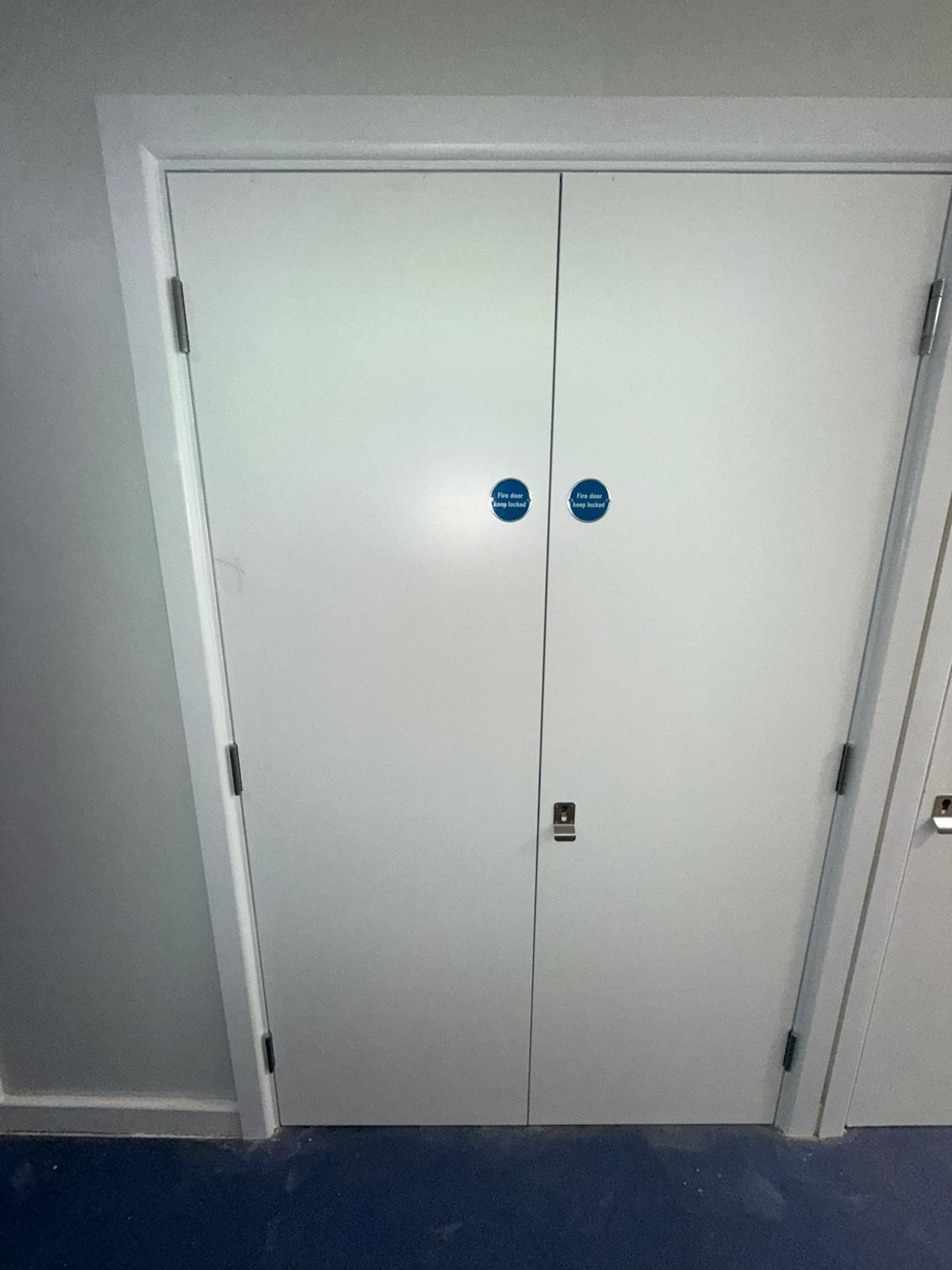 Paired service doors and keep-locked signage, Smithfield Court