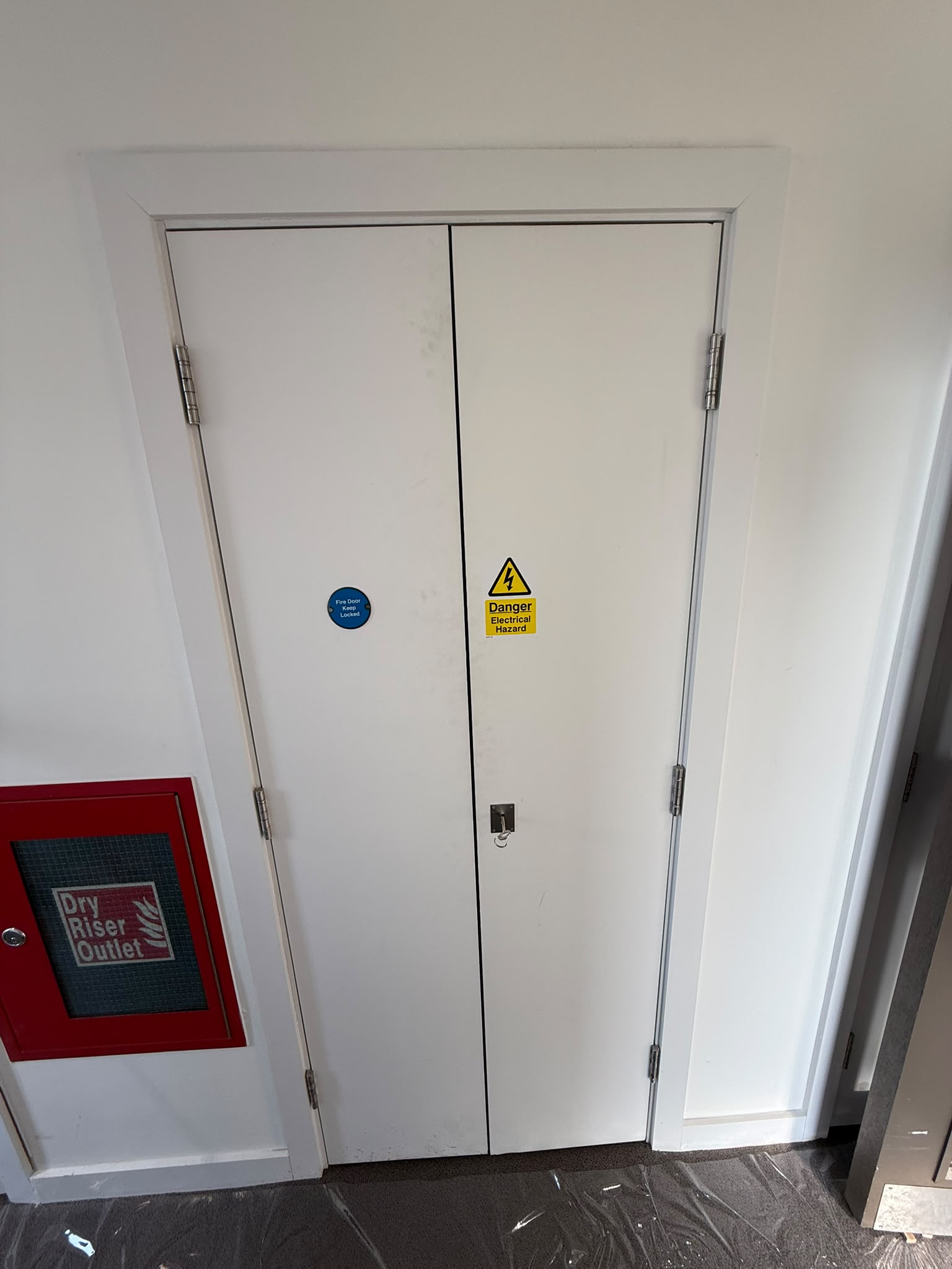 Service-cupboard doorset with fire-door signage, Frampton Park