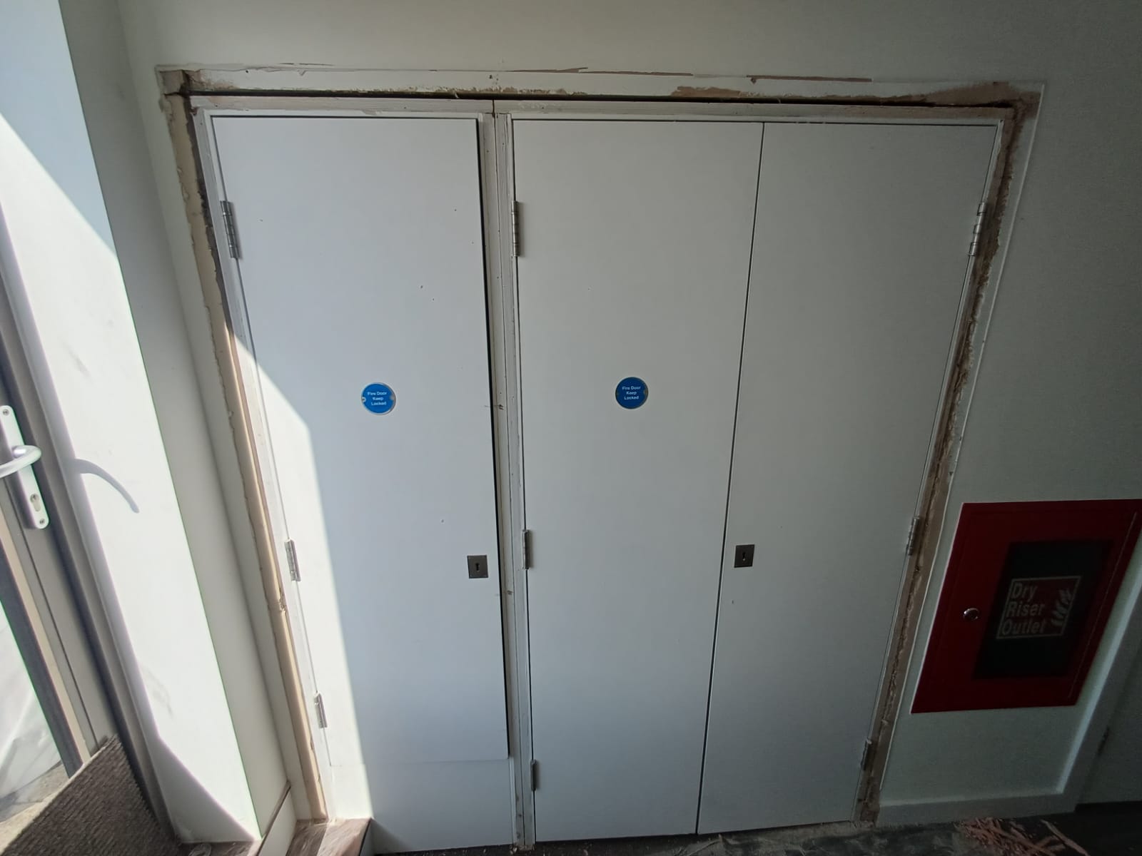 Paired service doors during frame-perimeter works, Frampton Park