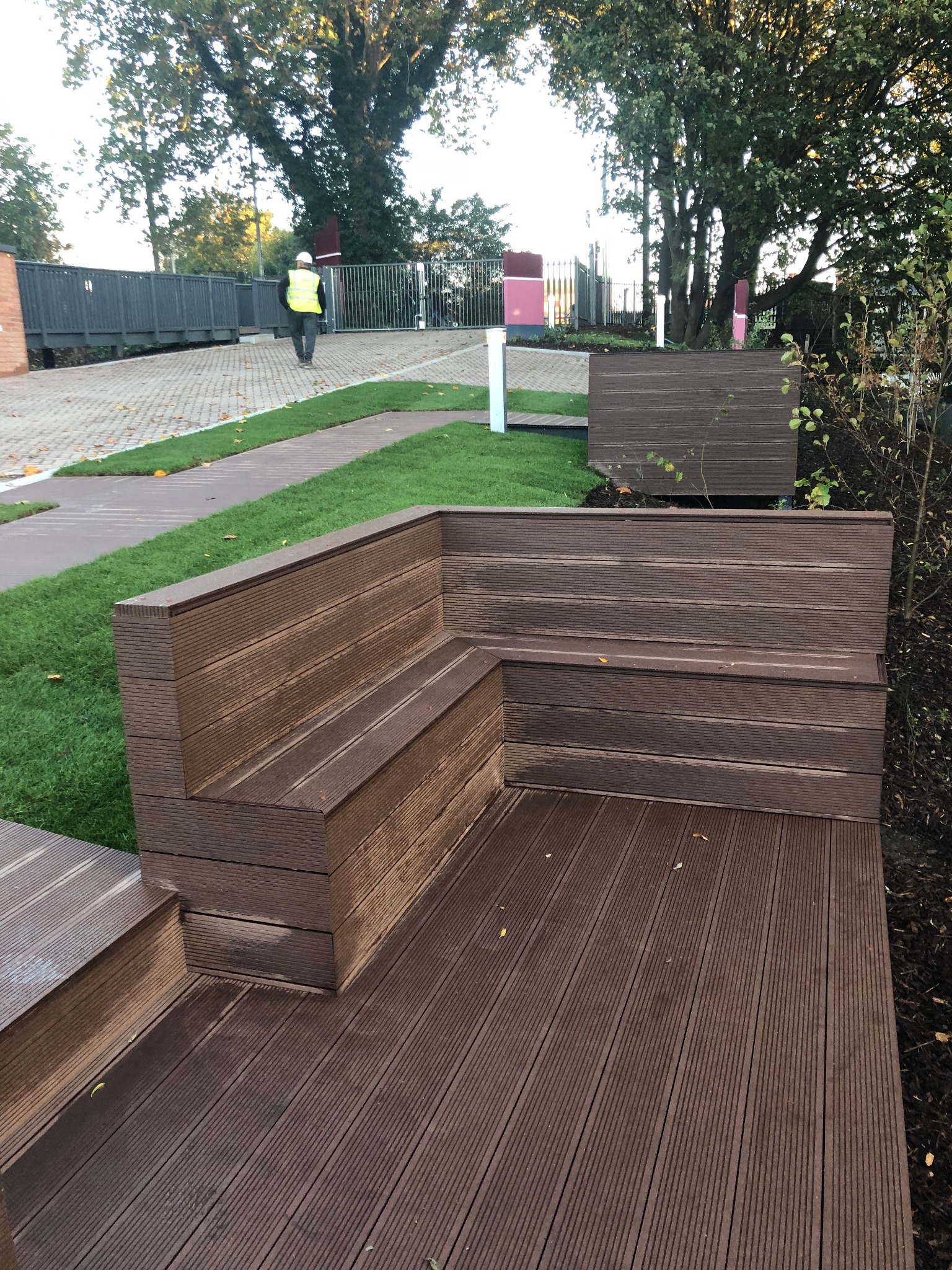 Timber framed benches beside the landscaped courtyard, Reading Riverside