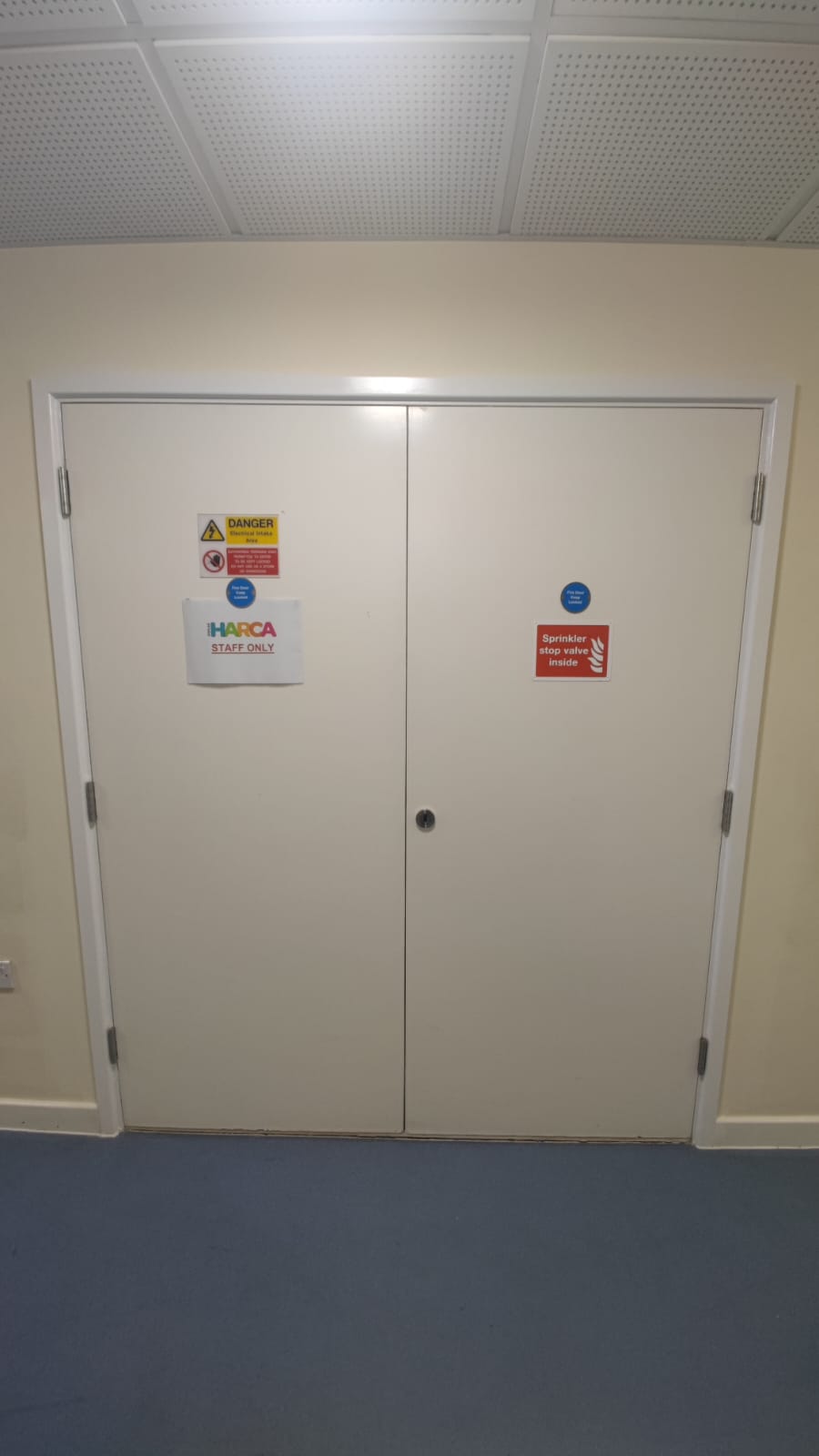Paired service doors with fire-door signage, Tynee Court