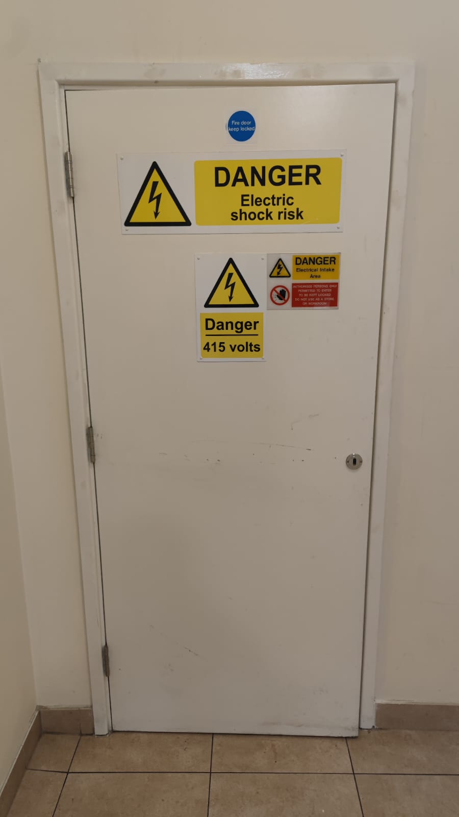 Single service door with electrical warning signage, Tynee Court