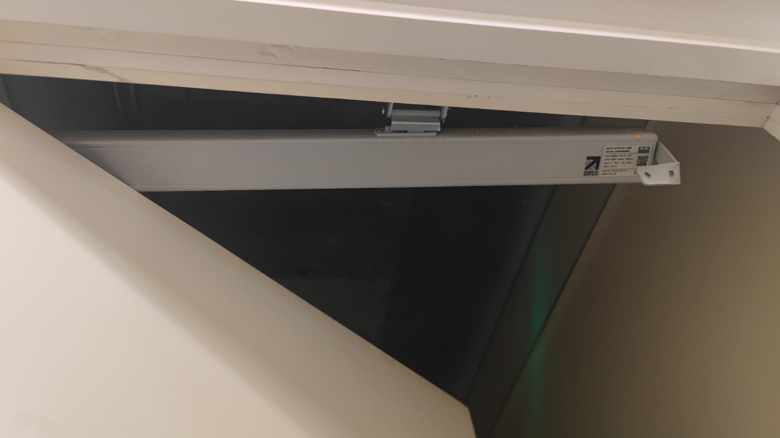 Closer mechanism above an open service door, Tynee Court