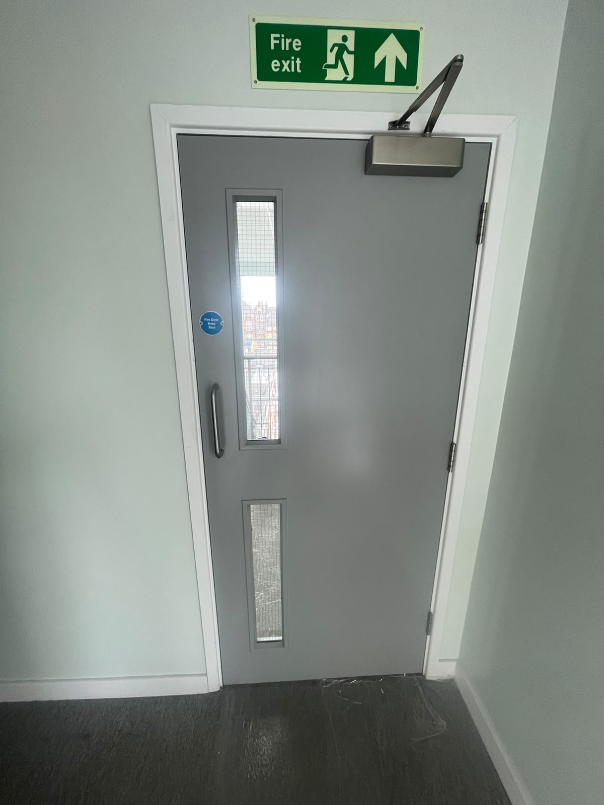 Communal door with vision panels and overhead closer, Radcliff Court