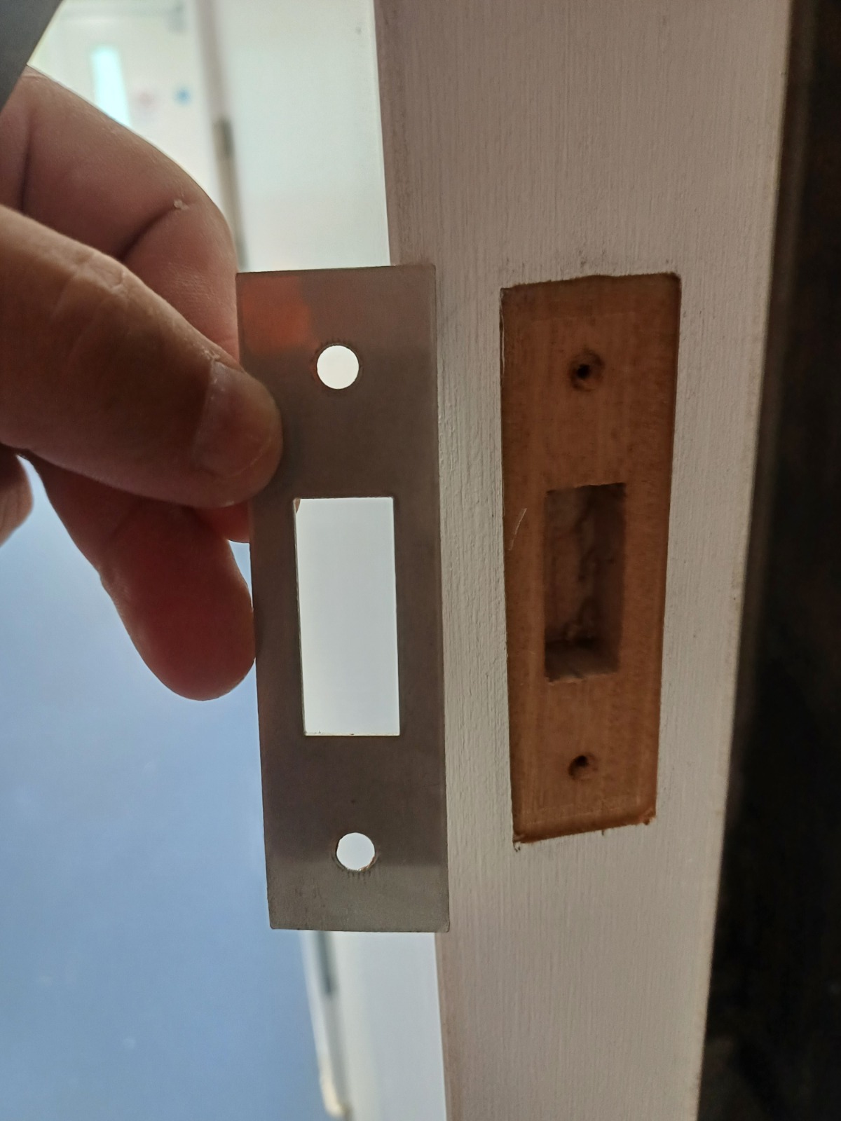 Latch-plate work during door maintenance, Smithfield Court