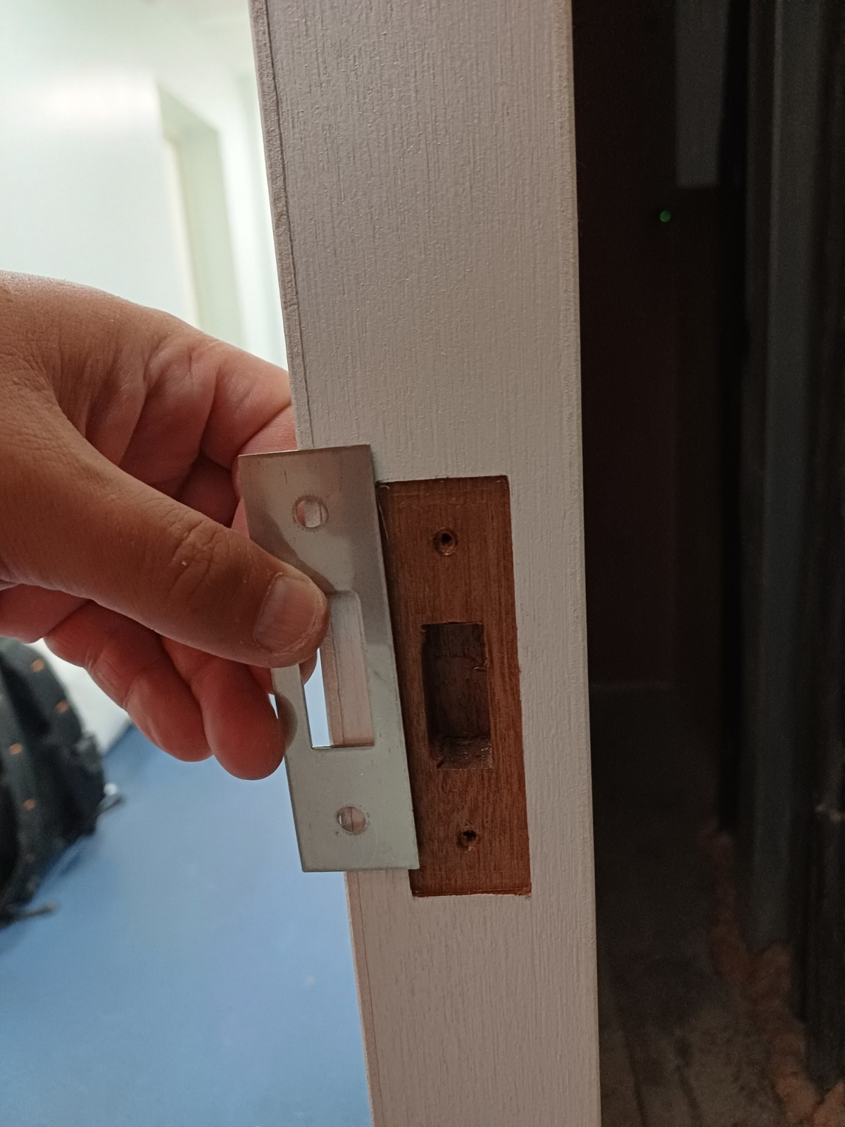Strike-plate removal during cupboard-door maintenance, Burlington Court