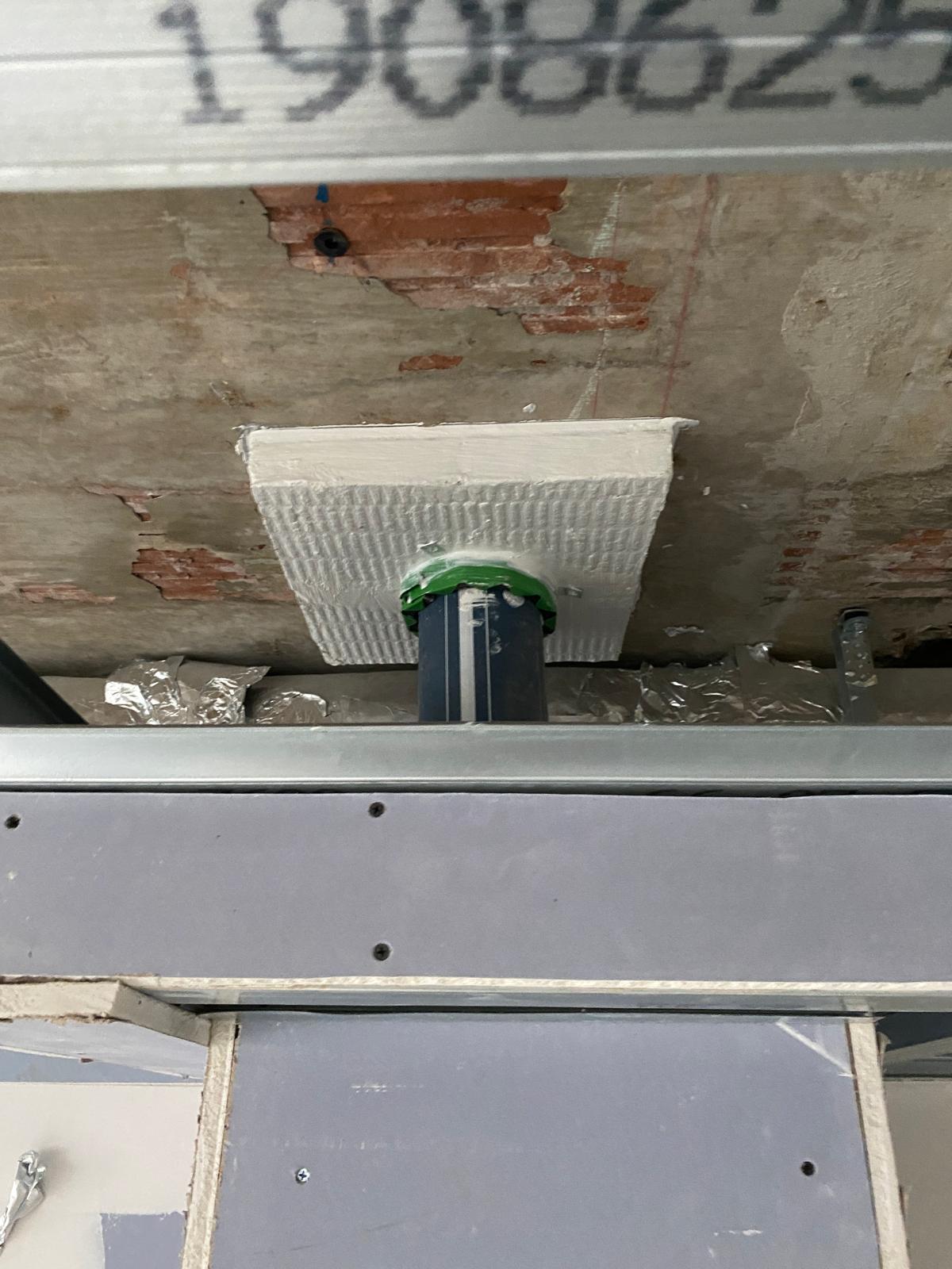 Vertical pipe penetration with a collar, Cobham firestopping project