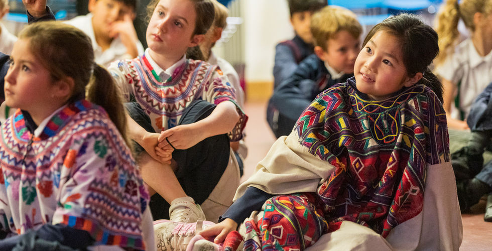 KS2 students listening to a talk during Culture Day