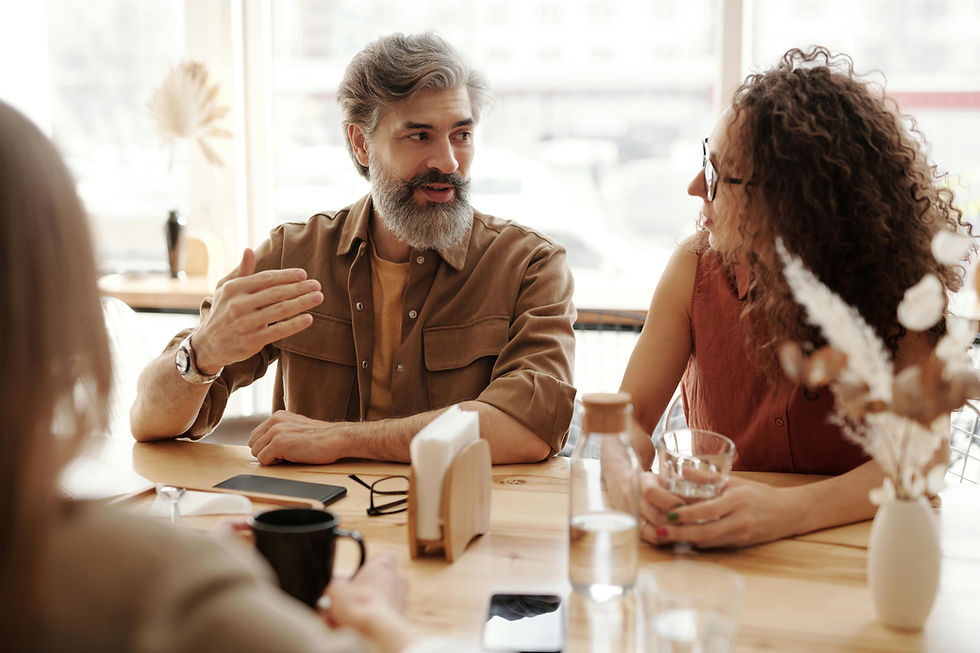 A man talking to a woman at a table at work