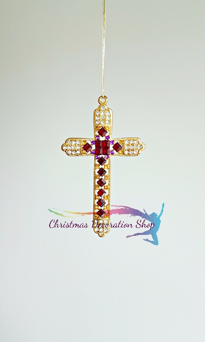 Luxury gold cross tree ornament with hand-placed ruby, purple, and clear crystals hanging from a gold string.