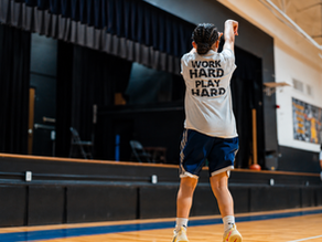 Youth basketball player follows through on a jump shot at Hoops and Handles.