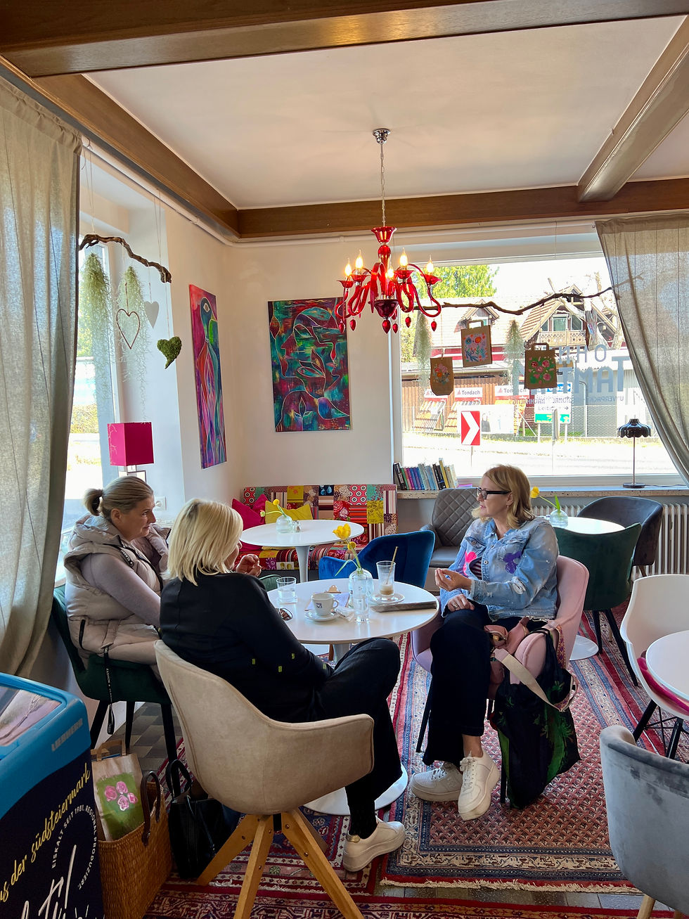 Close-up view of a cup of coffee on a wooden table with a small plant