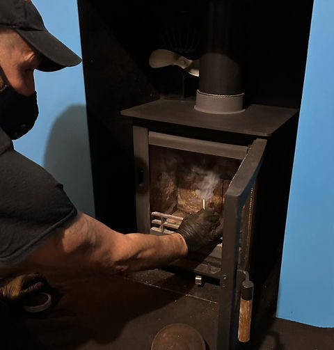 man doing a smoke test up a chimney