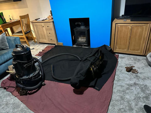 vacuum machine on sheets on the floor ready to sweep chimney