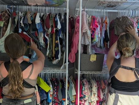 Participants of Options Pregnancy Centre Lennoxville's clothing exchange looking through baby clothes.