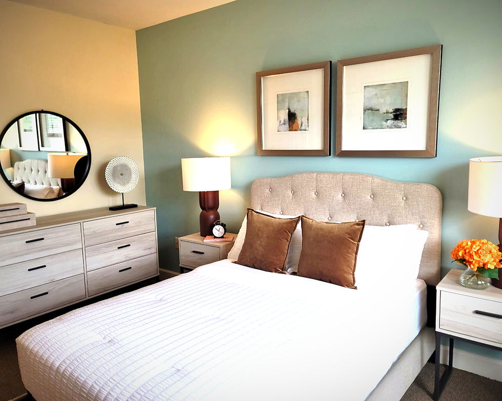 Staged bedroom with tufted headboard and natural wood tones.