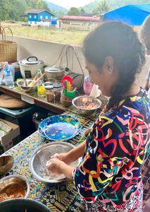 girl crushing coconut in a bowl (cooking)