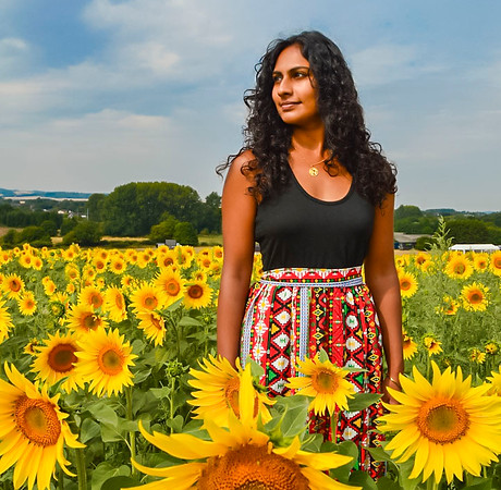 girl standing in sunflower field