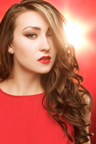 Woman with red lipstick and dress, BEAUTY, posing on a red background. Nick Johnson Photo