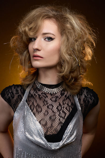 blonde model featuring retro glam hairstyle reminiscent of barbarella